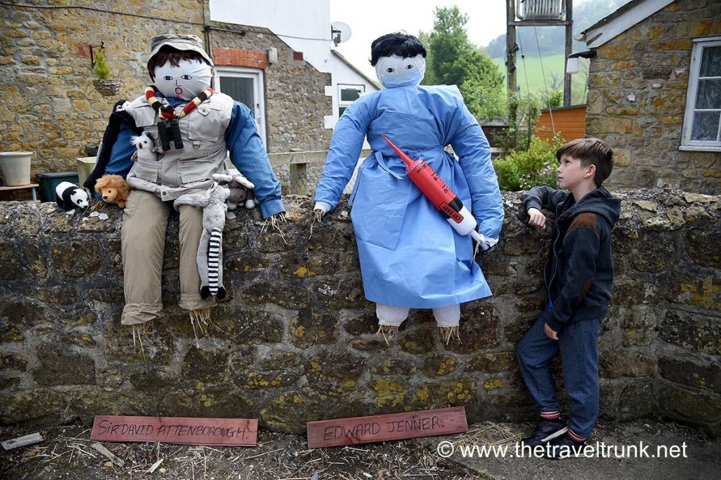 Scarecrows sitting on wall